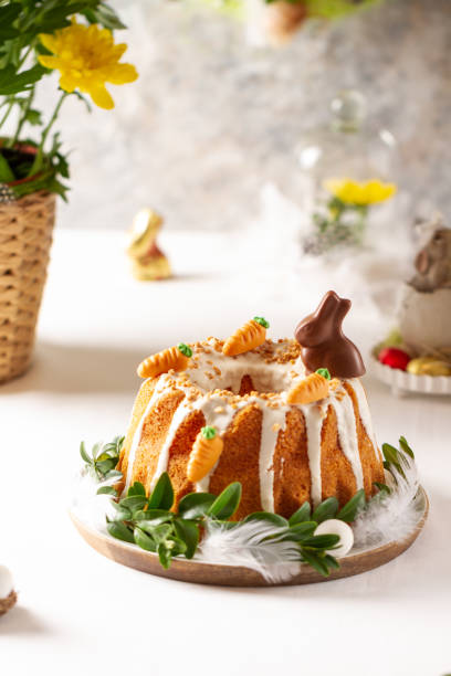 Easter lemon cake with icing and easter decoration. Easter gugelhupf cake with marzipan carrots and chocolate easter bunny