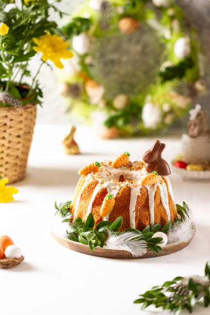 istock Easter lemon cake with icing and easter decoration. Easter gugelhupf cake with marzipan carrots and chocolate easter bunny 1215138092