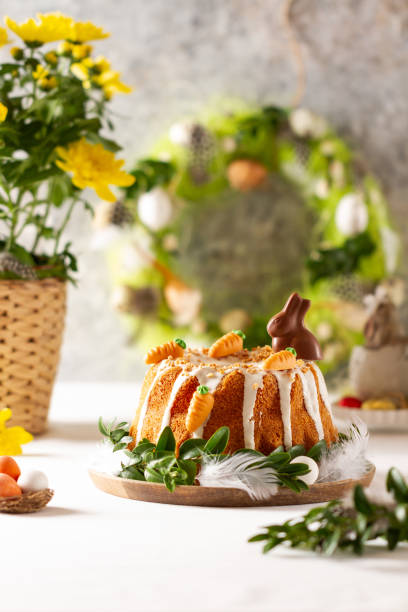 istock Easter lemon cake with icing and easter decoration. Easter gugelhupf cake with marzipan carrots and chocolate easter bunny 1215138309