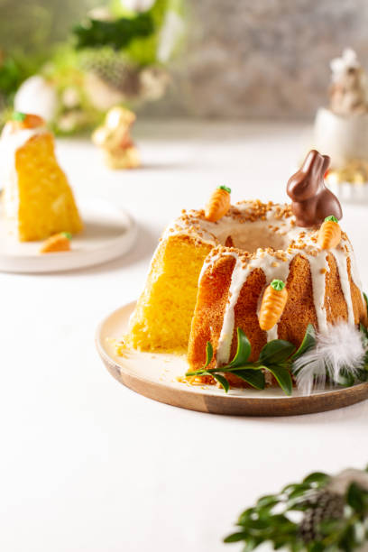 istock Easter lemon cake with icing and easter decoration. Easter gugelhupf cake with marzipan carrots and chocolate easter bunny 1215138311