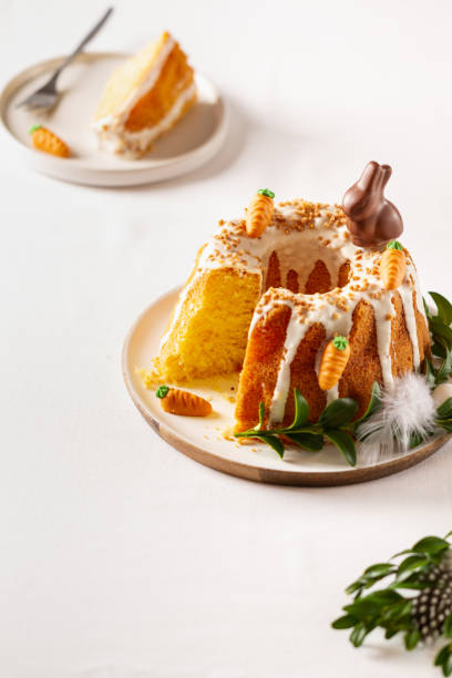 istock Easter lemon cake with icing and easter decoration. Easter gugelhupf cake with marzipan carrots and chocolate easter bunny 1215138381