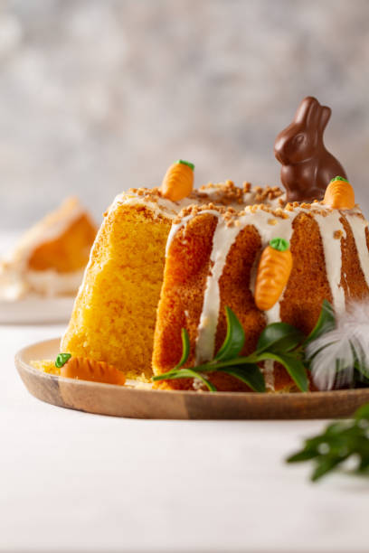 istock Easter lemon cake with icing and easter decoration. Easter gugelhupf cake with marzipan carrots and chocolate easter bunny 1215138457