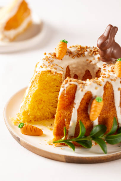 istock Easter lemon cake with icing and easter decoration. Easter gugelhupf cake with marzipan carrots and chocolate easter bunny 1215138536