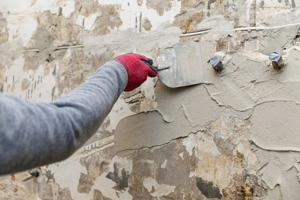 istock construction worker applying plaster on the old bathroom wall with spatula 1215138706