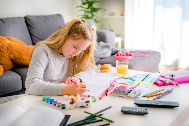 istock Little girl doing schoolwork at home 1215141700