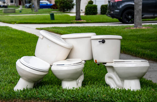 Toilets 3 random toilets on a sidewalk. They have been discarded but conjure up humorous themes. robertmichaud stock pictures, royalty-free photos & images
