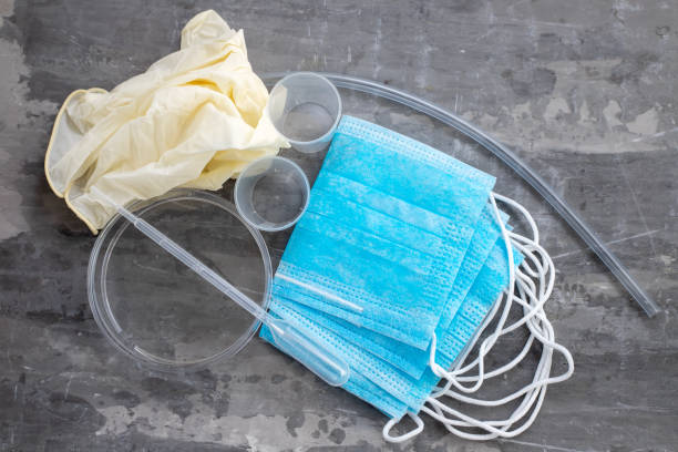istock medical mask, plastic cups and other objects on ceramic  background 1215144973