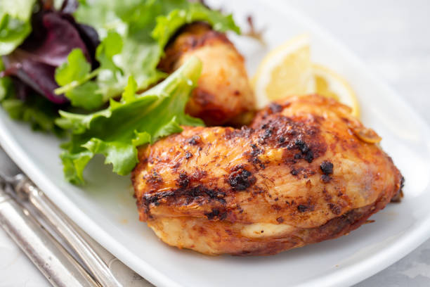 istock grilled chicken with lemon and salad on white dish 1215145058