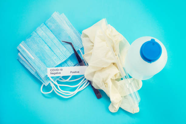 istock medical mask and disinfectant on blue  background 1215145059