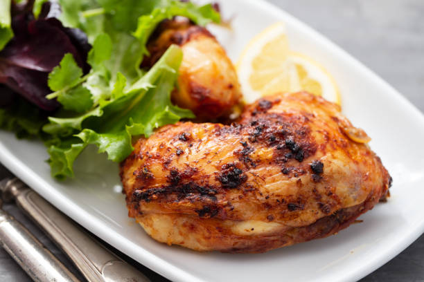 istock grilled chicken with lemon and salad on white dish 1215145072