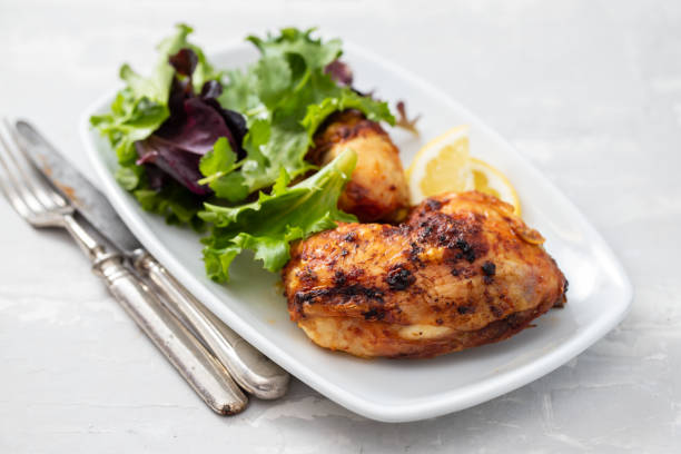 istock grilled chicken with lemon and salad on white dish 1215145170