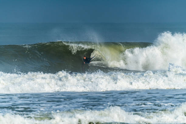 istock Bodyboarder surfing ocean wave 1215145343