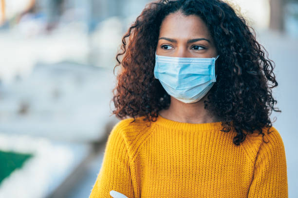 istock Woman with face protective mask 1215146541
