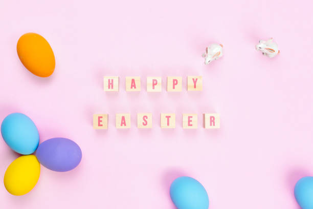 istock Easter day little Bunny rabbit with decorated eggs on pink background 1215148010