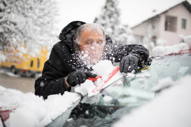 istock Cleaning car after snow 1215148954