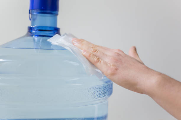 istock Wiping down surface of big water bottle 1215151340