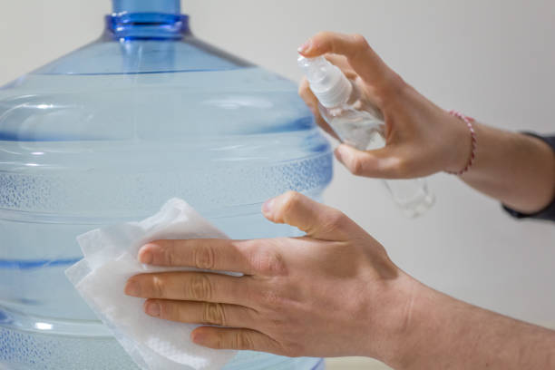 istock Wiping down surface of bottle 1215151365