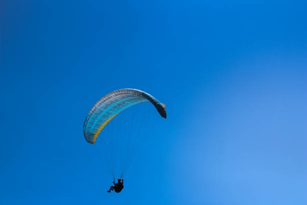 istock Paragliding in the blue sky 1215152714