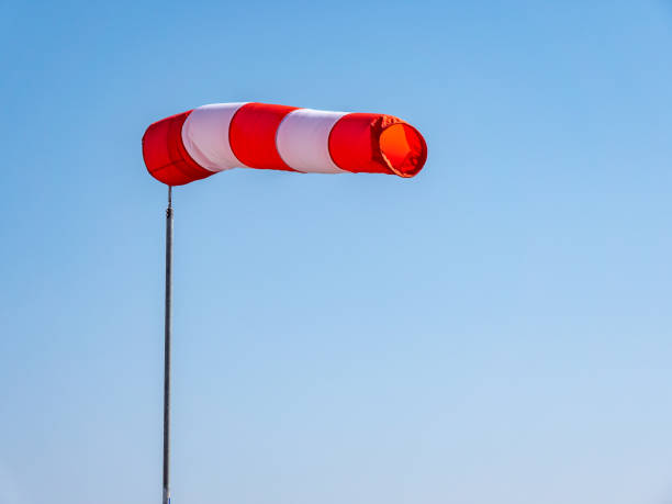 red white windsock with blue background - anemometer meteorology measuring wind imagens e fotografias de stock