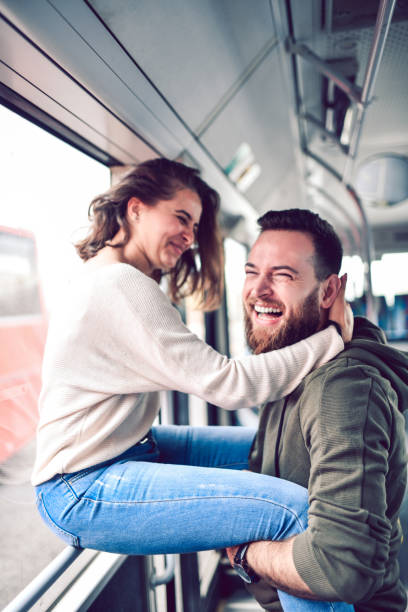 istock Male Embracing His Girlfriend And Lifting Her During Bus Ride 1215154809