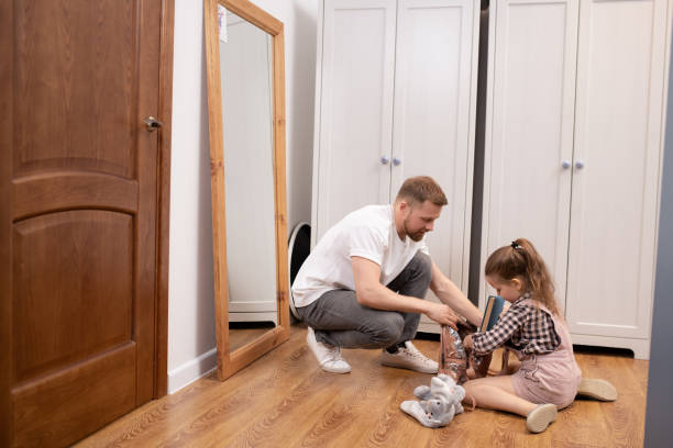 istock Young father helping his cute little elementary school daughter pack rucksack 1215157365