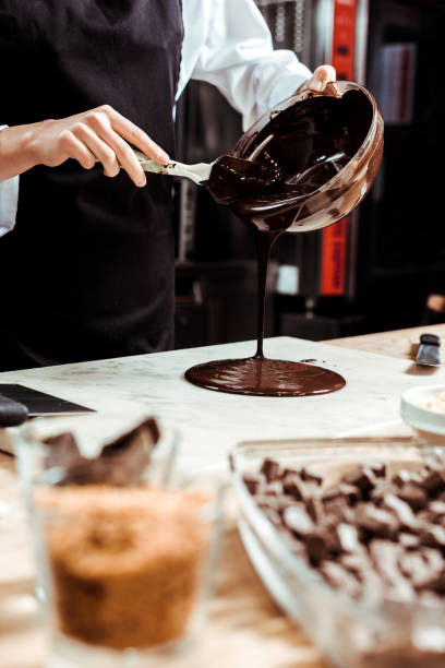 istock selective focus of chocolatier pouring melted chocolate on marble surface 1215159279