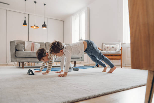 istock Children doing Yoga at home 1215159835