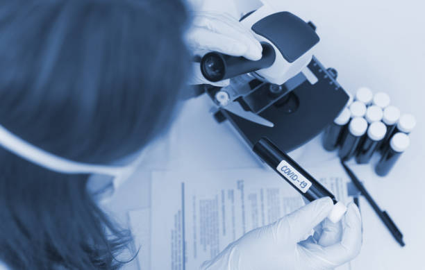 istock Scientist in laboratory working with microscope. Covid-19 concept. 1215161535