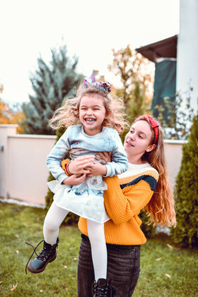 istock Cute Sister Playing Together In Home Courtyard 1215161816