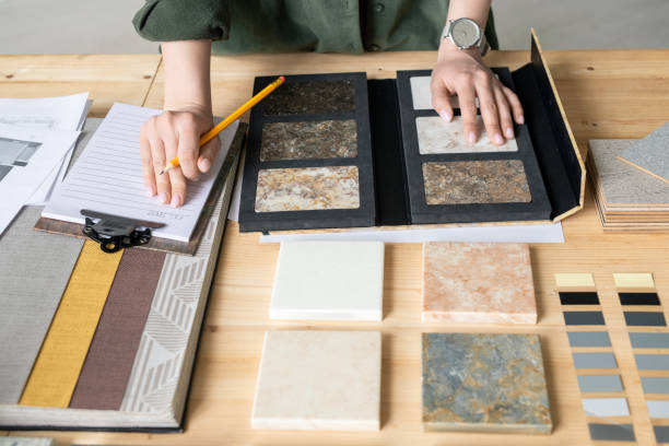 istock Hands of young woman making notes on paper while choosing sample of panel 1215162894