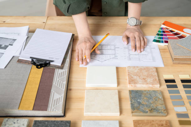 istock Hands of young creative female designer or architect working with sketches 1215162899