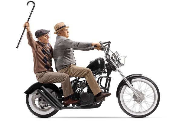 istock Two senior men riding on a custom chopper motorbike 1215166904
