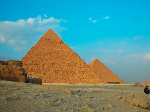 The great pyramid of Cheops in Cairo, Egypt. Pyramids of Khafra against the blue sky. Old residential buildings of the poor quarter of Giza, Egypt.