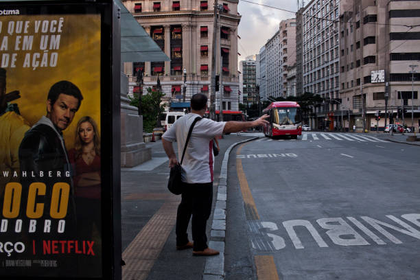 Sao Paulo, SP,  Brazil- March 23rd, 2020: A man calls a bus on Xavier de Toledo street in downtown São Paulo almost empty during quarantine.