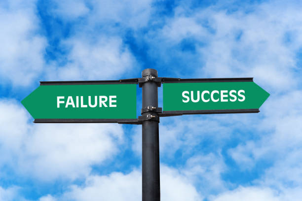 istock Success or Failure: conceptual directional sign against blue sky with clouds 1215168431