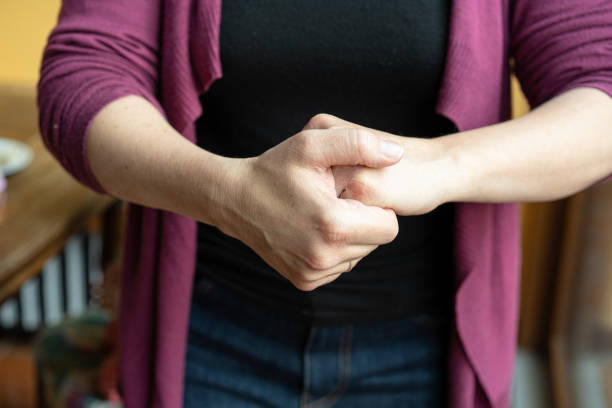 istock Woman cleaning her hand with antibacterial cream 1215170225