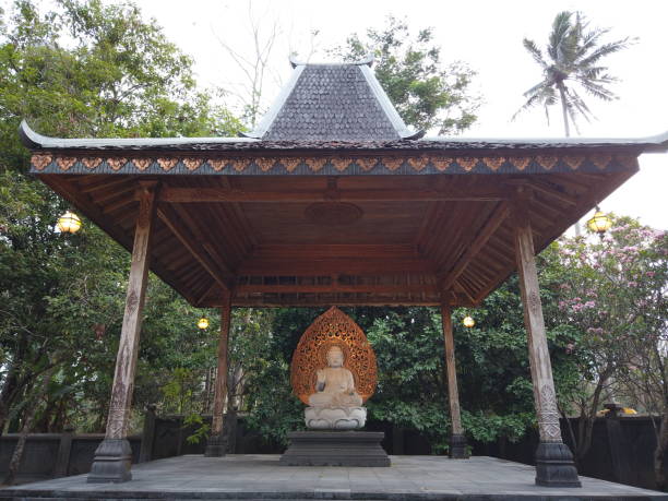 istock Pagoda with white statue of Buddha in a park 1215172149