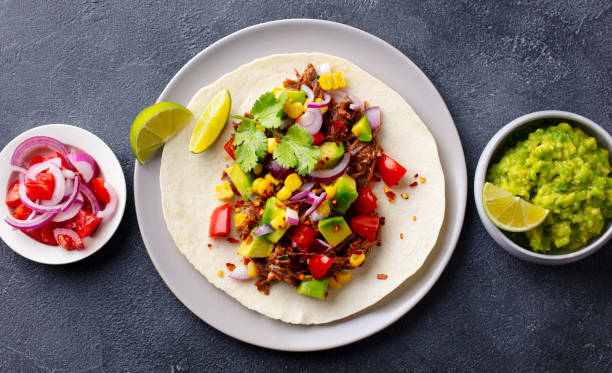 istock Taco with meat and vegetables. Dark background. Close up. Top view. 1215174566