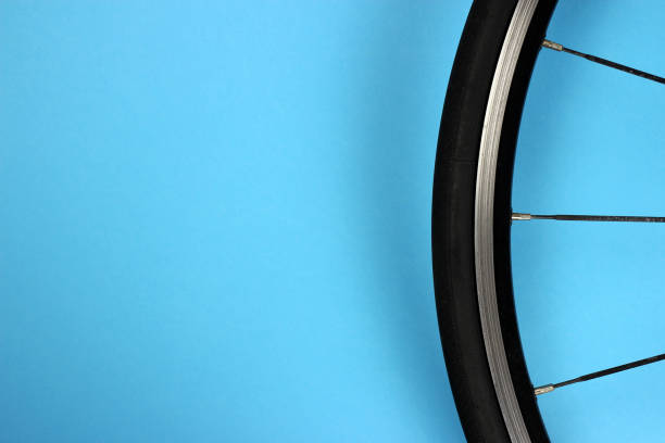 istock road bike wheel on a blue background. Copyspace for your text 1215174598