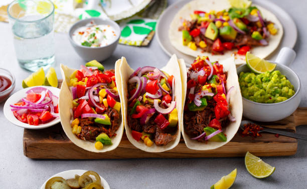 istock Taco with meat and vegetables on cutting board. Grey background. Close up. 1215174806