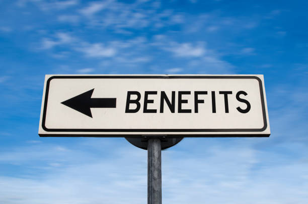 istock Benefits road sign, arrow on blue sky background 1215175837