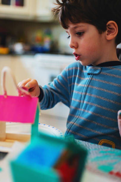 istock Boy Painting Birdhouse 1215176698