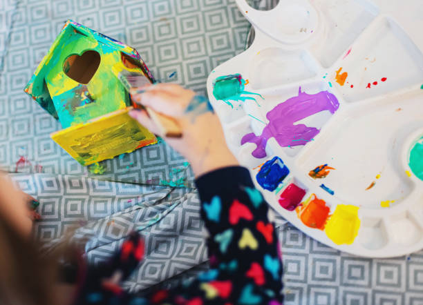 istock Girl Painting Birdhouse 1215176721