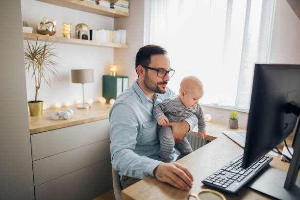 istock Young father working from home and babysitting his baby boy in the same time. 1215178136