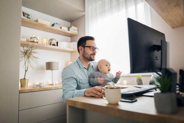 istock Young father working from home and babysitting his baby boy in the same time. 1215178156