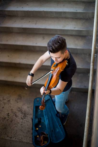 istock Street musician playing violin 1215178689