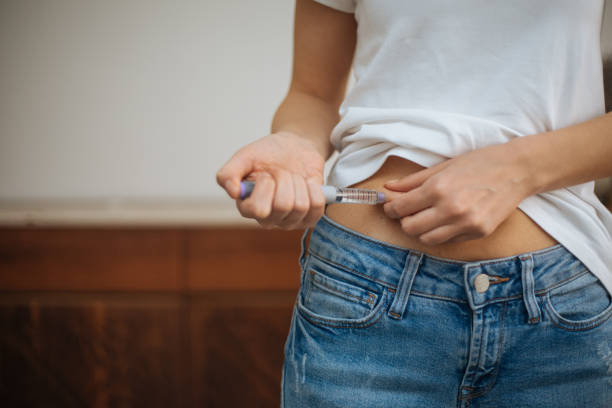 istock Woman doing insulin injection 1215178872