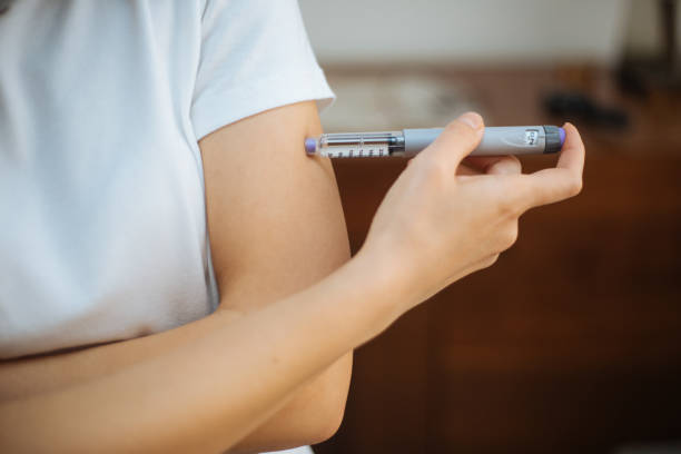 istock Woman doing insulin injection 1215178878