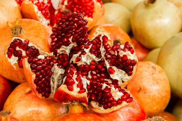istock Ripe pomegranate with red juicy seeds. 1215180221