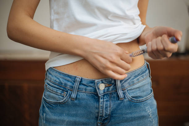 istock Woman doing insulin injection 1215180394